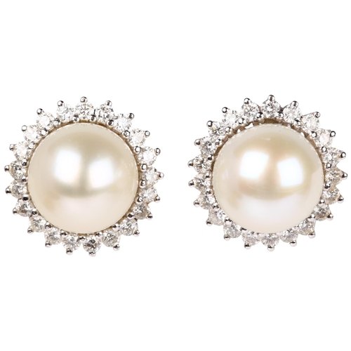 1155 - A pair of 18ct white gold whole pearl and diamond flowerhead cluster earrings, claw set with modern ... 