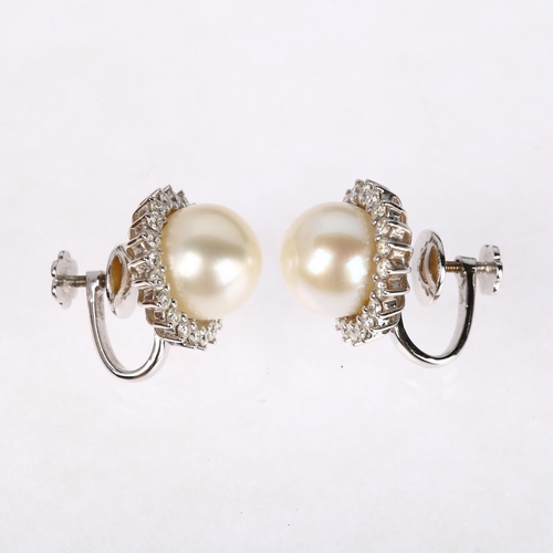 1155 - A pair of 18ct white gold whole pearl and diamond flowerhead cluster earrings, claw set with modern ... 