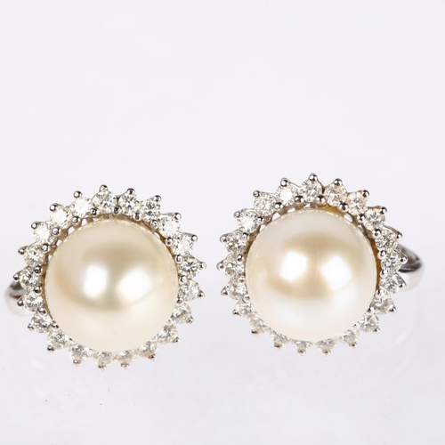 1155 - A pair of 18ct white gold whole pearl and diamond flowerhead cluster earrings, claw set with modern ... 