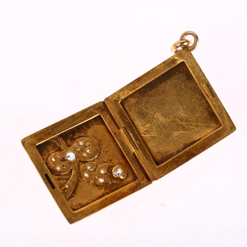 1169 - An early 20th century 18ct gold diamond and white sapphire locket pendant, square form with ribbon m... 