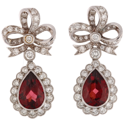 1173 - A pair of South African 14ct white gold garnet and diamond drop earrings, by Charles Greig, with mod... 