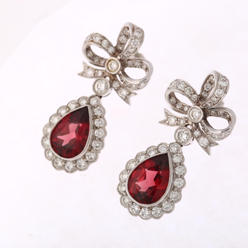 1173 - A pair of South African 14ct white gold garnet and diamond drop earrings, by Charles Greig, with mod... 