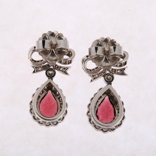 1173 - A pair of South African 14ct white gold garnet and diamond drop earrings, by Charles Greig, with mod... 