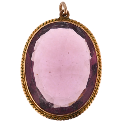 1181 - A large amethyst pendant, rub-over set with oval mixed-cut amethyst within unmarked yellow metal rop... 