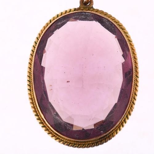 1181 - A large amethyst pendant, rub-over set with oval mixed-cut amethyst within unmarked yellow metal rop... 