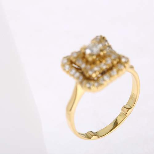 1186 - A late 20th century 18ct gold diamond cluster ring, import London 1980, square stepped wavy form, pa... 