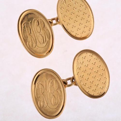 1198 - A pair of 9ct gold oval cufflinks, maker SB, with engine turned decoration, 18.8mm, 14.1g