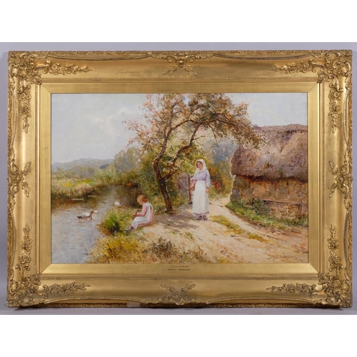 607 - Ernest Walbourn (1872 - 1927), feeding the ducks, oil on canvas, signed, 51cm x 76cm, framed