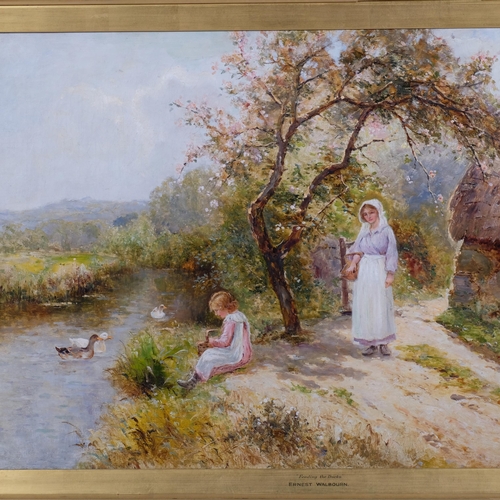 607 - Ernest Walbourn (1872 - 1927), feeding the ducks, oil on canvas, signed, 51cm x 76cm, framed