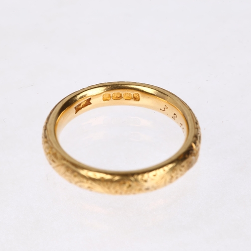 1212 - A heavy early 20th century 18ct gold wedding band ring, maker WJP, London 1913, with engraved foliat... 