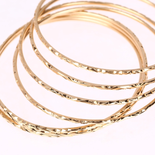 1216 - A set of 7 x 14ct gold slave bangles with engraved decoration, each band width 1.9mm, internal circu... 