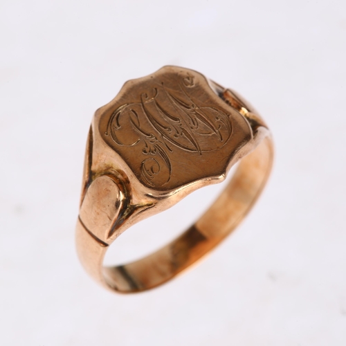 1225 - An early 20th century 9ct rose gold shield signet ring, engraved with initials MW, indistinct hallma... 