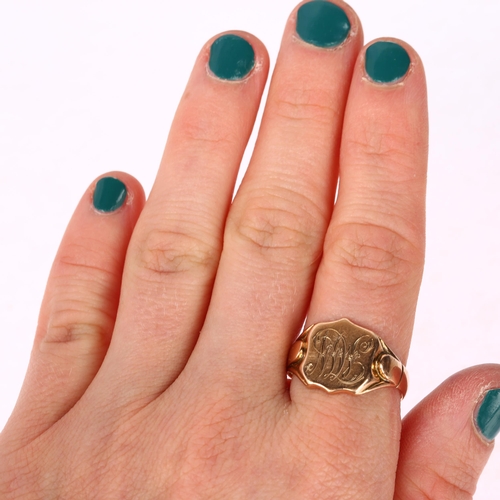 1225 - An early 20th century 9ct rose gold shield signet ring, engraved with initials MW, indistinct hallma... 