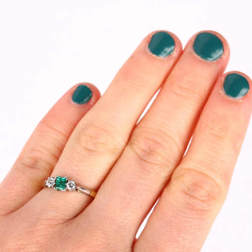 1242 - An 18ct gold three stone emerald and diamond ring, set with 0.25ct rectangular step-cut emerald flan... 