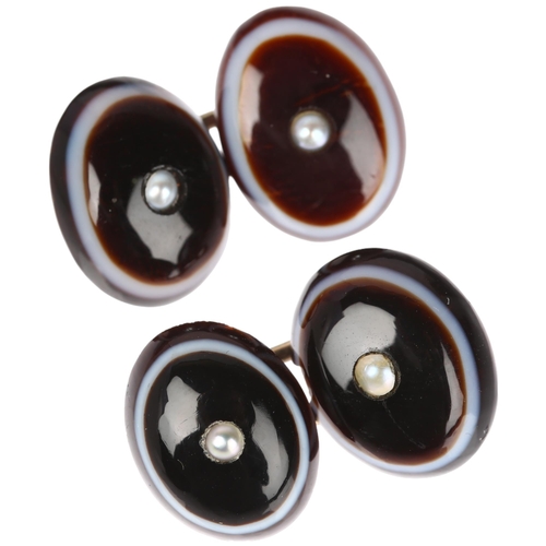 1243 - A pair of banded agate and split pearl oval cufflinks, unmarked yellow metal fittings with oval cabo... 