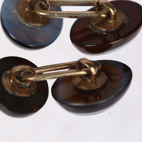 1243 - A pair of banded agate and split pearl oval cufflinks, unmarked yellow metal fittings with oval cabo... 