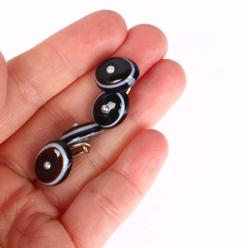 1243 - A pair of banded agate and split pearl oval cufflinks, unmarked yellow metal fittings with oval cabo... 