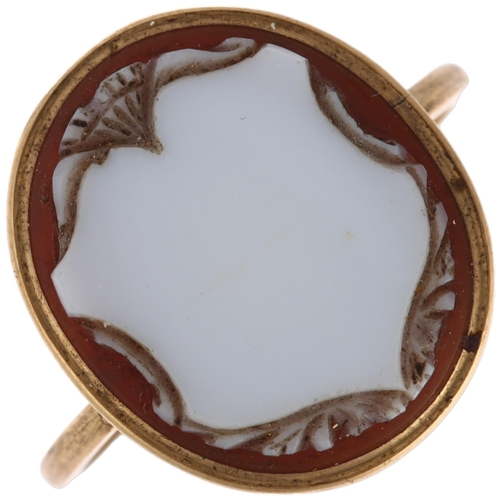 1246 - An Antique sardonyx shield cameo ring, unmarked gold settings with relief carved panel depicting vac... 