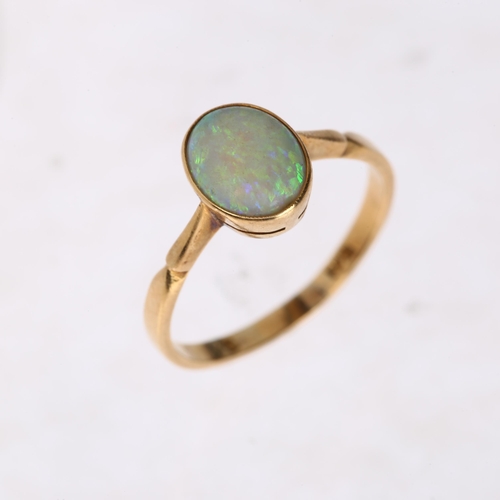 1252 - A late 20th century solitaire opal ring, unmarked gold settings with rub-over set oval cabochon opal... 