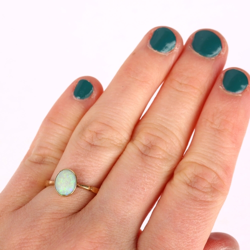 1252 - A late 20th century solitaire opal ring, unmarked gold settings with rub-over set oval cabochon opal... 