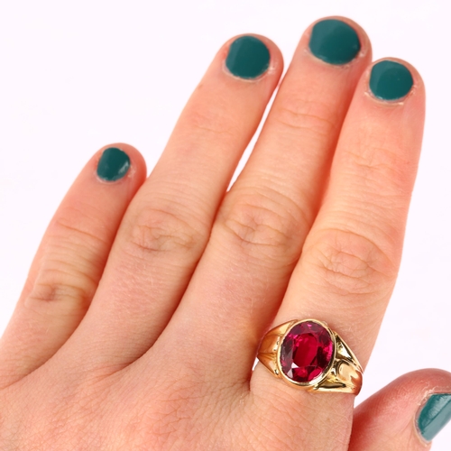 1257 - A synthetic ruby signet ring, unmarked gold settings, rub-over set with oval mixed-cut synthetic rub... 