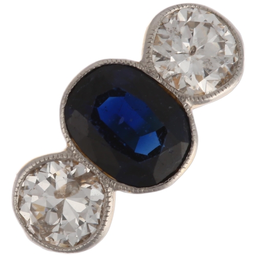 1261 - An 18ct gold three stone sapphire and diamond ring, platinum-topped, rub-over set with 0.8ct oval mi... 