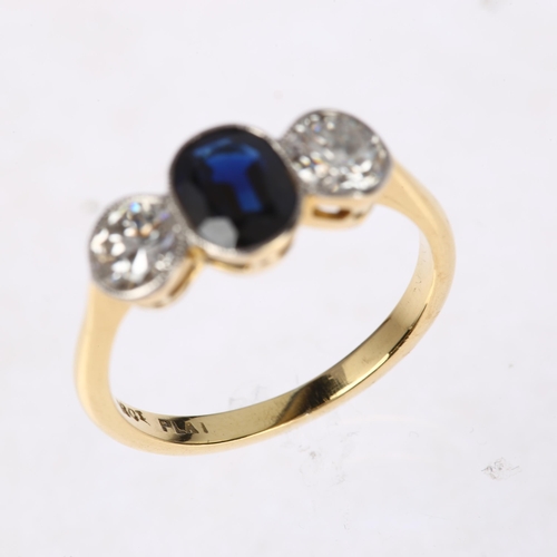 1261 - An 18ct gold three stone sapphire and diamond ring, platinum-topped, rub-over set with 0.8ct oval mi... 