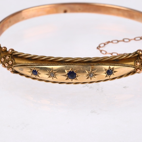 1262 - A Victorian 9ct rose gold sapphire and diamond hinged bangle, with applied rope twist and floral dec... 