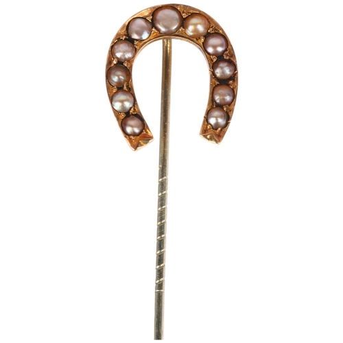 1275 - A Victorian split pearl horseshoe stickpin, unmarked yellow metal settings, head 21.2mm, overall 65.... 