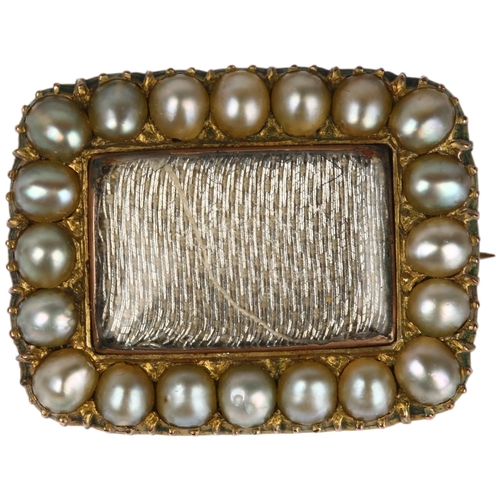 1287 - A Georgian split pearl mourning brooch, central dedication panel beneath convex glass within collet ... 