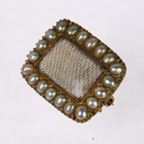 1287 - A Georgian split pearl mourning brooch, central dedication panel beneath convex glass within collet ... 