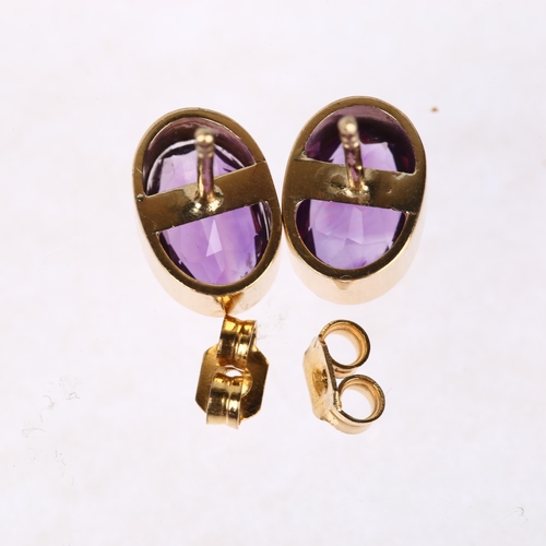 1293 - A pair of solitaire amethyst earrings, unmarked yellow metal rub-over settings with oval mixed-cut a... 