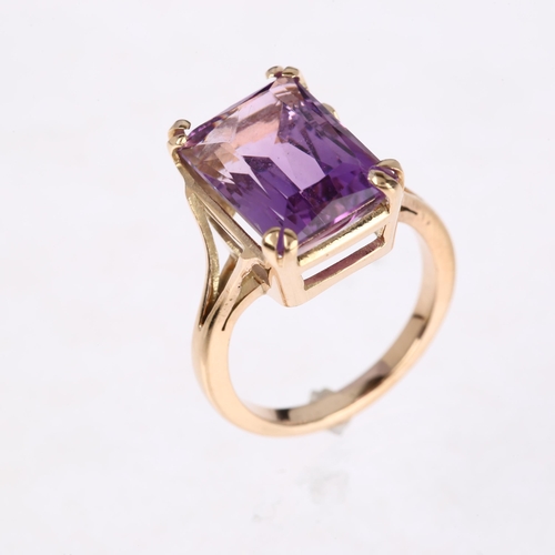 1306 - A late 20th century amethyst dress ring, unmarked rose gold settings with rectangular scissor-cut am... 