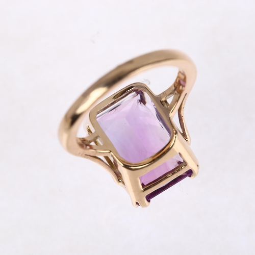 1306 - A late 20th century amethyst dress ring, unmarked rose gold settings with rectangular scissor-cut am... 