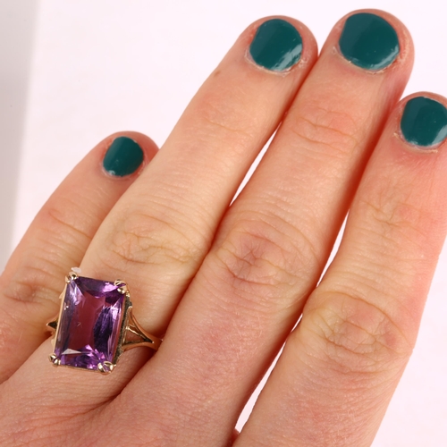 1306 - A late 20th century amethyst dress ring, unmarked rose gold settings with rectangular scissor-cut am... 