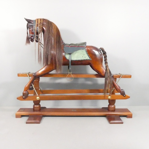 STEVENSON BROTHERS - A painted wooden rocking horse, "Sebastian", in chestnut, with carved nose and mouth, leather tack and horse hair main and tail. With maker's plaque, numbered 2555 and dated 1997. Overall dimensions length 178cm, height 148cm, 56cm.