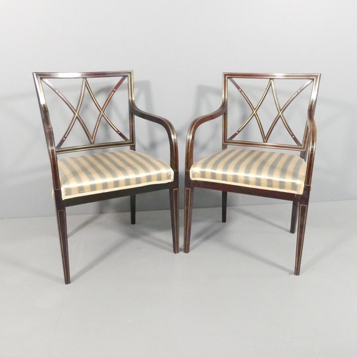 2021 - A pair of mid-century mahogany and brass line inlaid open arm or desk chairs.