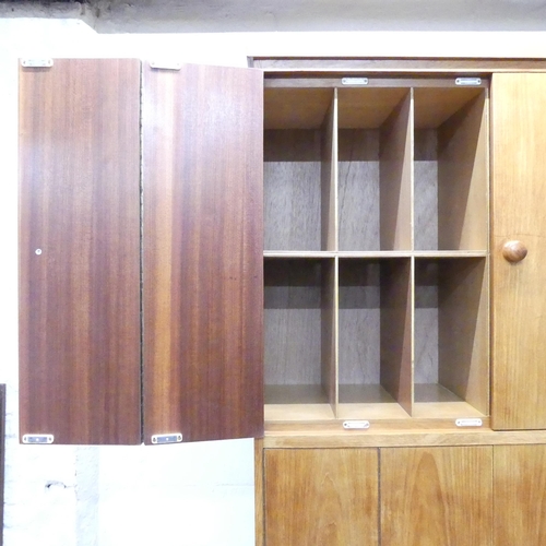 2025 - A mid-century oak record / vinyl cabinet, having four bi-fold doors and fitted interior. 102x203x46c... 