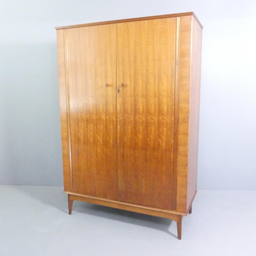 2039 - ALFRED COX - a mid-century teak and satin walnut two-door wardrobe, with rail fitted interior and ma... 