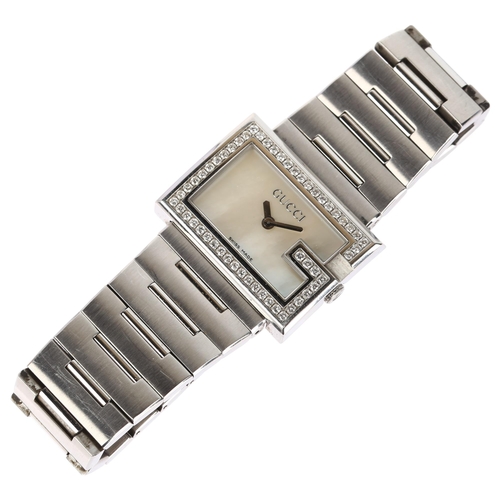 1099 - GUCCI - a lady's stainless steel 100L quartz bracelet watch, circa 1992, white mother-of-pearl dial ... 