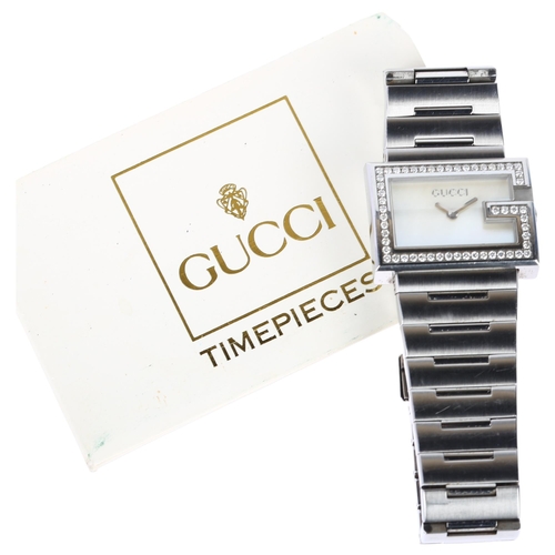 1099 - GUCCI - a lady's stainless steel 100L quartz bracelet watch, circa 1992, white mother-of-pearl dial ... 