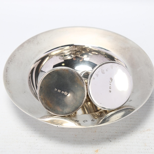 1704 - An Elizabeth II silver Armada dish, and a pair of silver pepperettes, 4.7oz total (3)