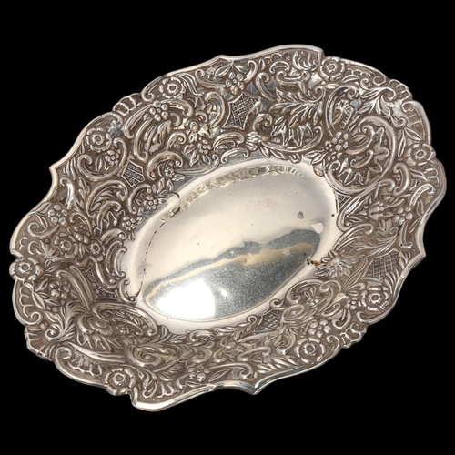 1708 - A Victorian silver table centre bowl, William Aitken, Chester 1884, allover relief embossed foliate ... 