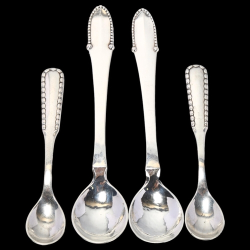 1715 - GEORG JENSEN - a pair of Art Deco Danish silver Kugel pattern mustard spoons, and a pair of Perl pat... 