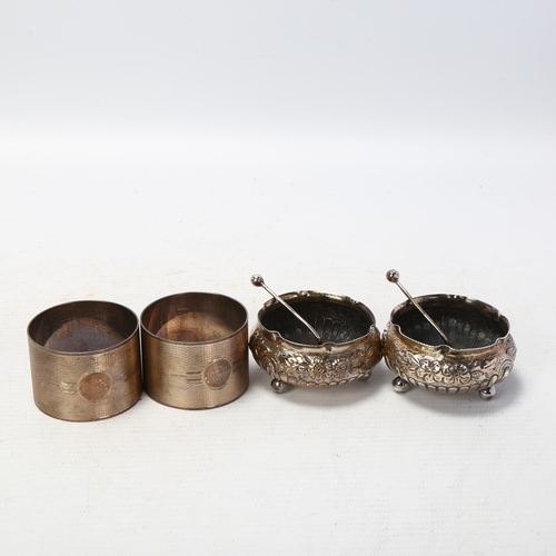 1723 - A cased pair of silver napkin rings, and a cased pair of silver salt cellars, 3.3oz total