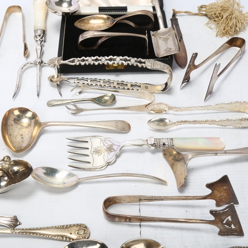 1727 - Various silver and plated flatware, including shovel caddy spoon, sugar tongs, mother-of-pearl handl... 