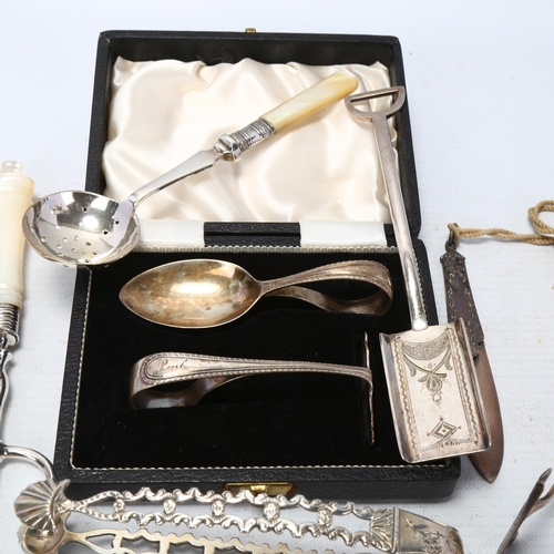 1727 - Various silver and plated flatware, including shovel caddy spoon, sugar tongs, mother-of-pearl handl... 