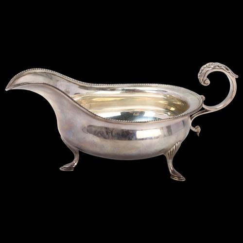 1766 - A George V silver sauce boat, Joseph Rodgers & Sons Ltd, Sheffield 1912, with beaded rim and a scrol... 