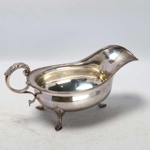 1766 - A George V silver sauce boat, Joseph Rodgers & Sons Ltd, Sheffield 1912, with beaded rim and a scrol... 