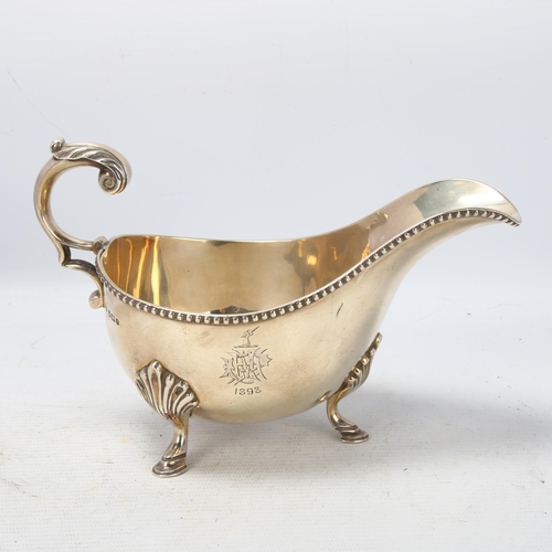 1767 - A late Victorian silver sauce boat, Mappin & Webb, Sheffield 1897, with beaded rim, scrolled acanthu... 